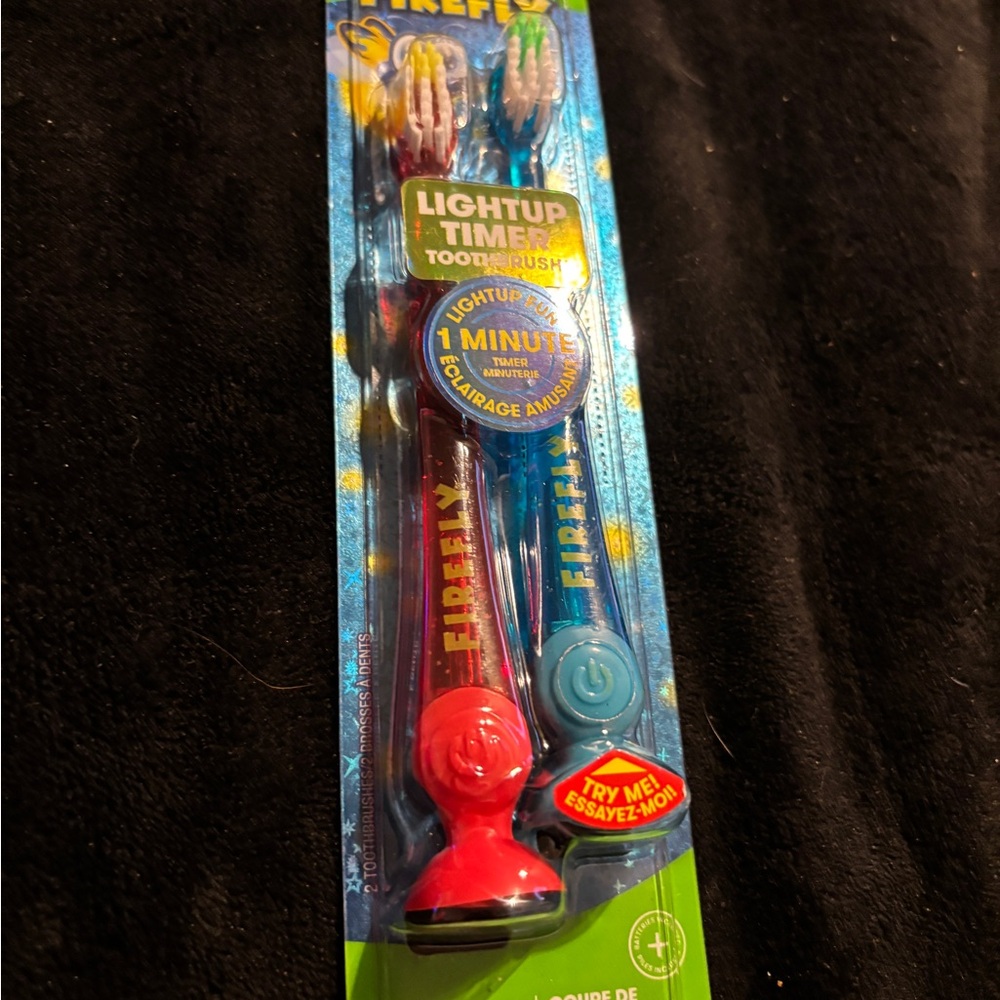 Firefly Light-Up Timer Toothbrush Set of two - Red and Blue. New sealed